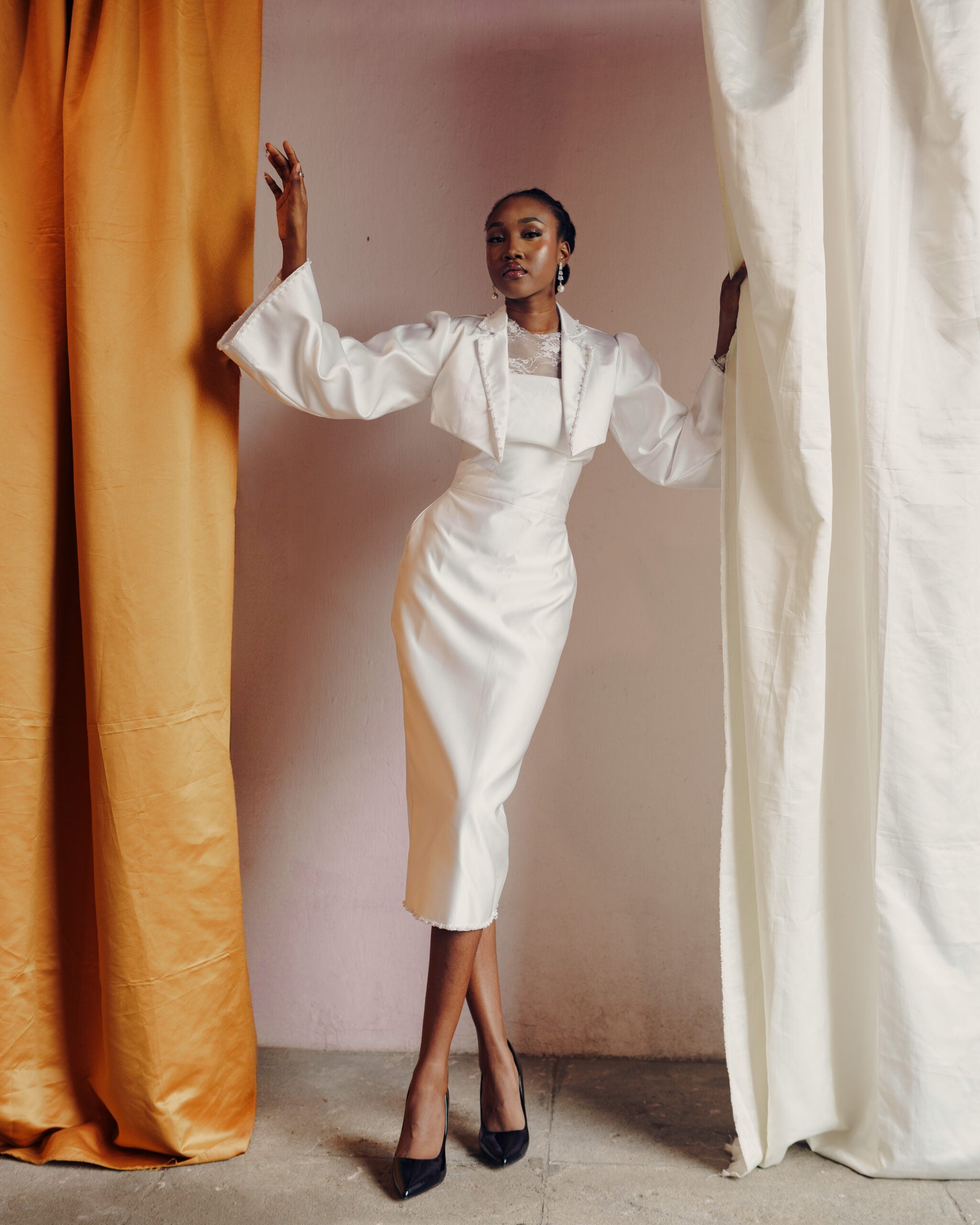 Woman Elegantly Dresses in white with legs crosed