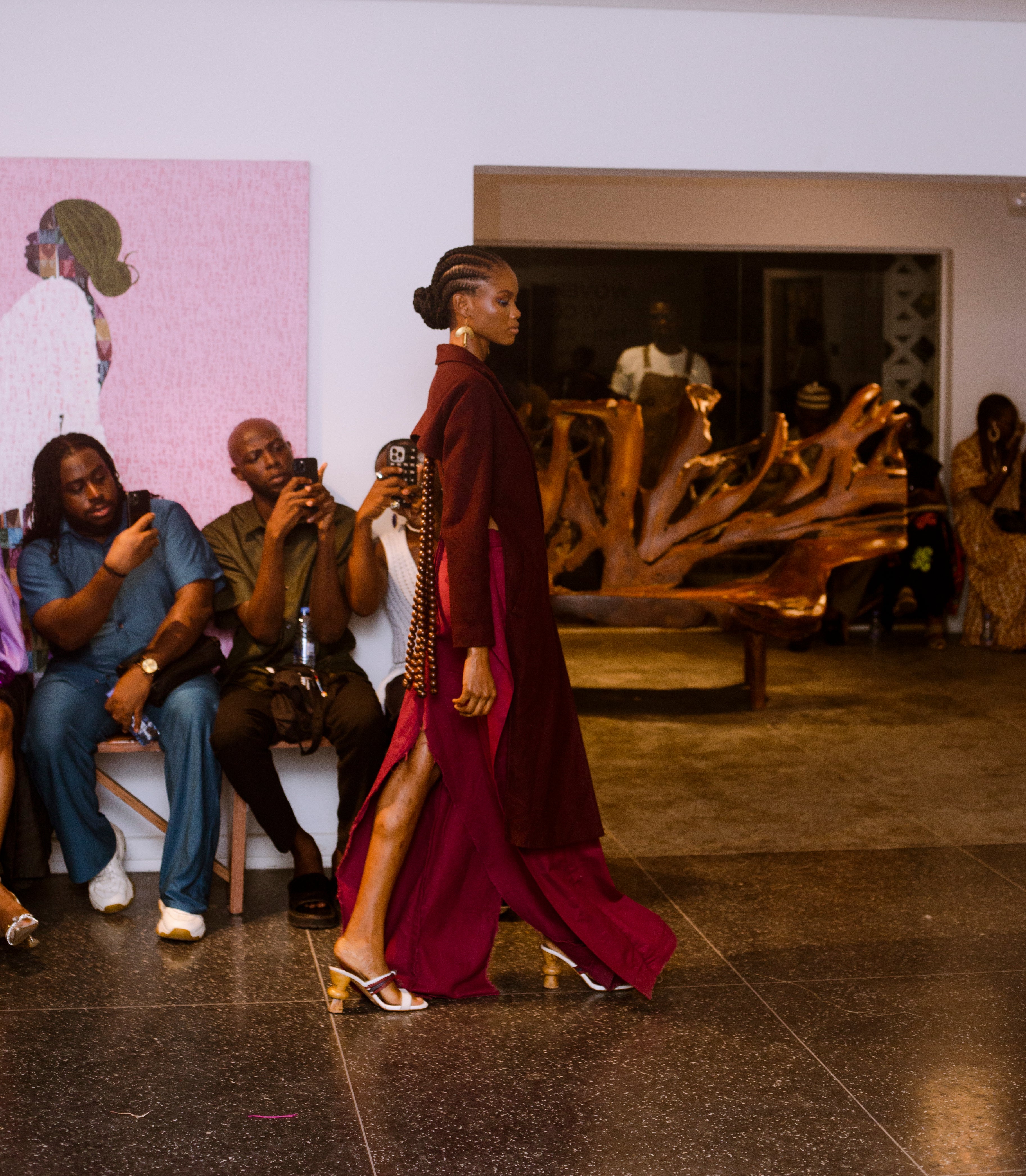 well styled African Model, dressed in a wine colored dress elegantly posed