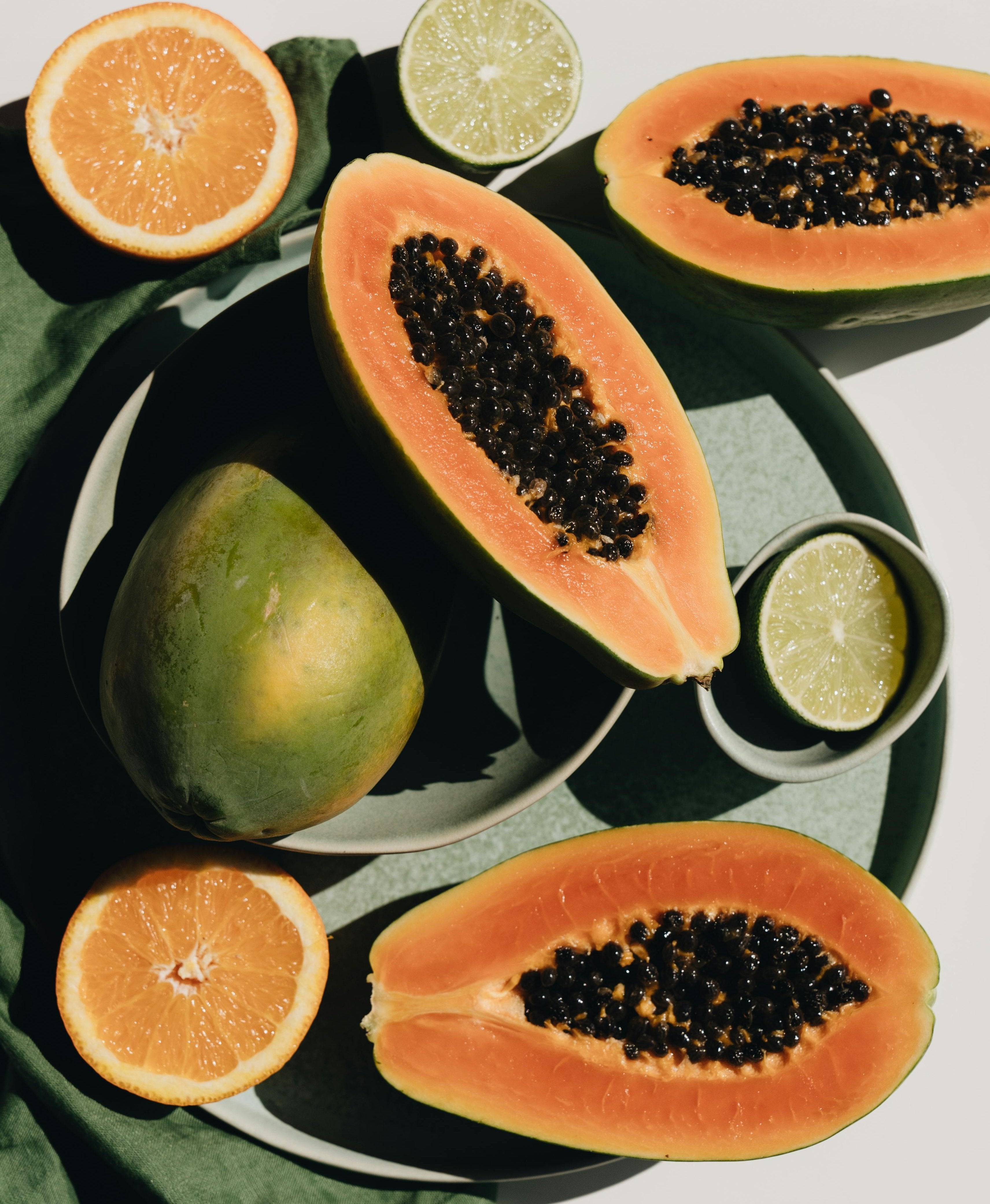 Sliced Pawpaw and Orange under bright sunlight