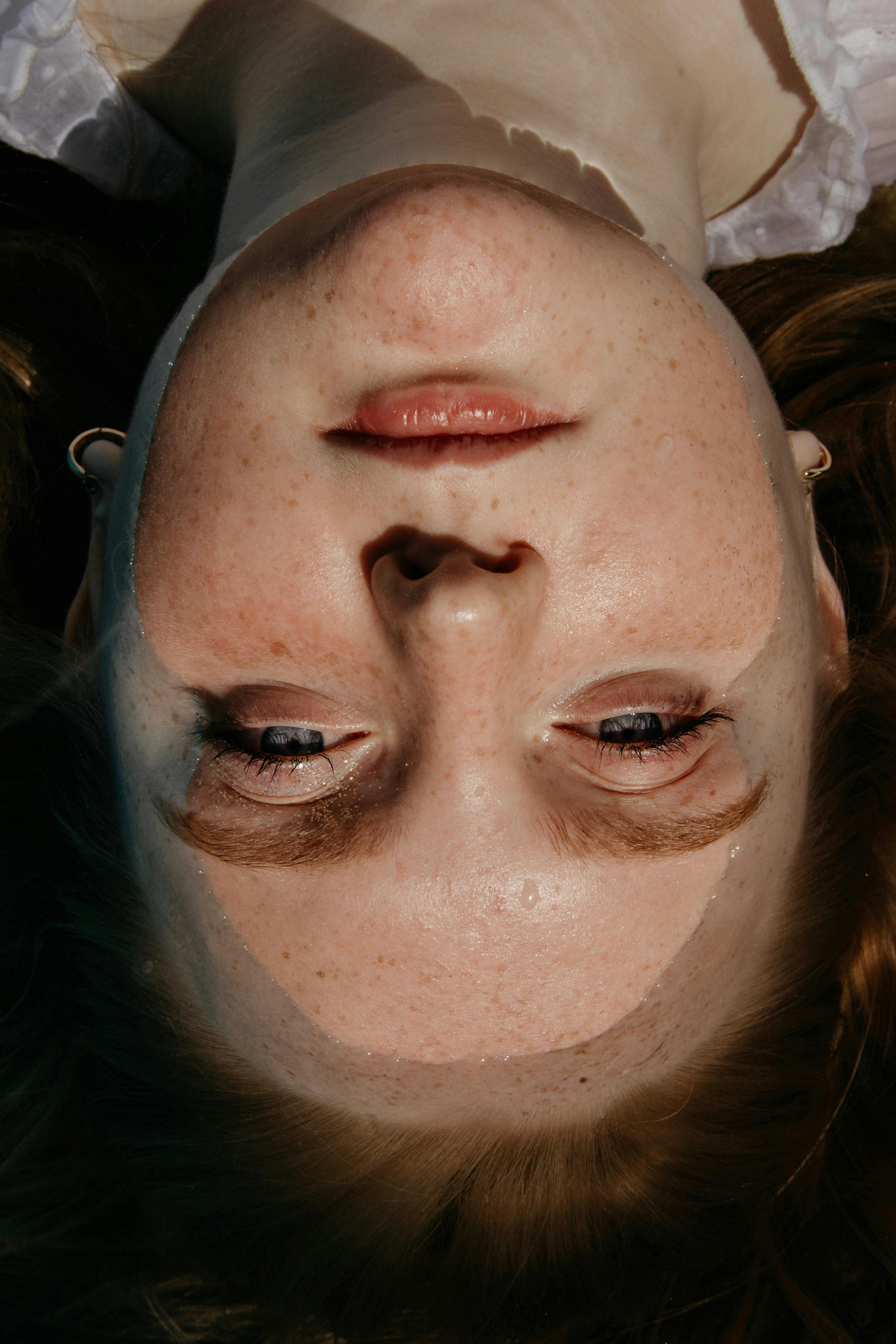 Woman Facing  up while in water with part of her Head dipped in water